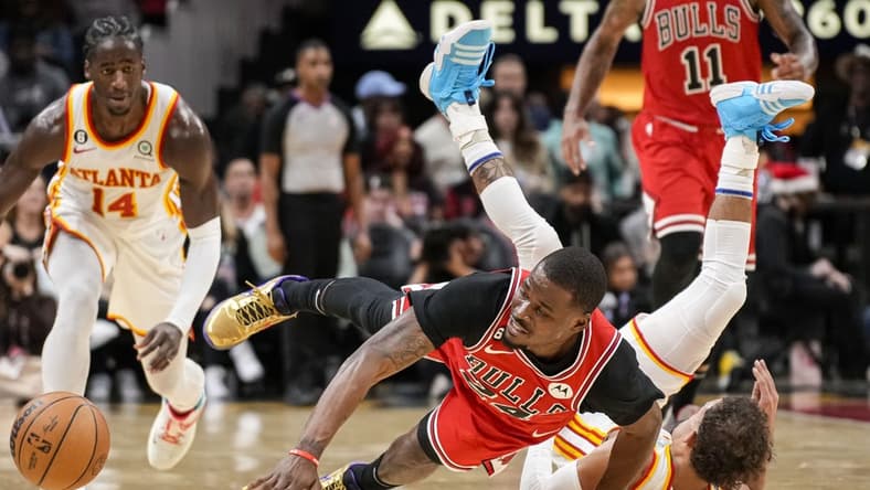 Dec 11, 2022; Atlanta, Georgia, USA; Chicago Bulls forward Javonte Green (24) and Atlanta Hawks guard Trae Young (11) fight for the ball on the floor during the second half at State Farm Arena. Mandatory Credit: Dale Zanine-USA TODAY Sports