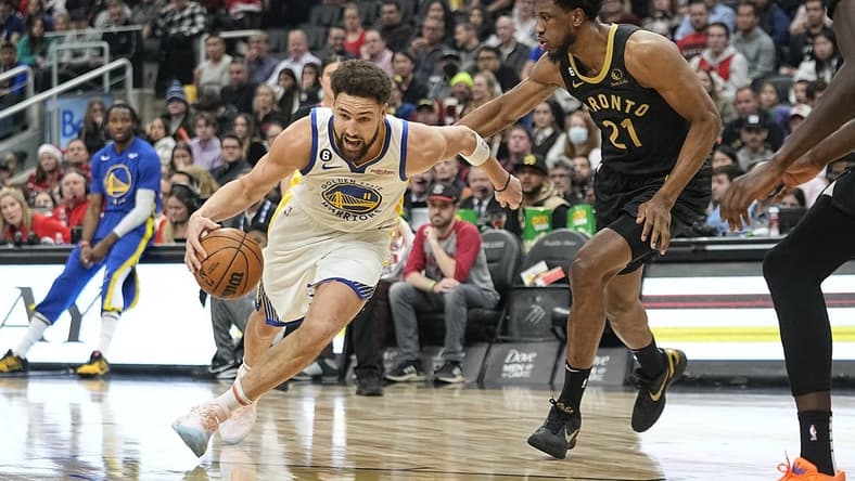 Dec 18, 2022; Toronto, Ontario, CAN; Golden State Warriors guard Klay Thompson (11) drives to the net against Toronto Raptors forward Thaddeus Young (21) during the first half at Scotiabank Arena. Mandatory Credit: John E. Sokolowski-USA TODAY Sports