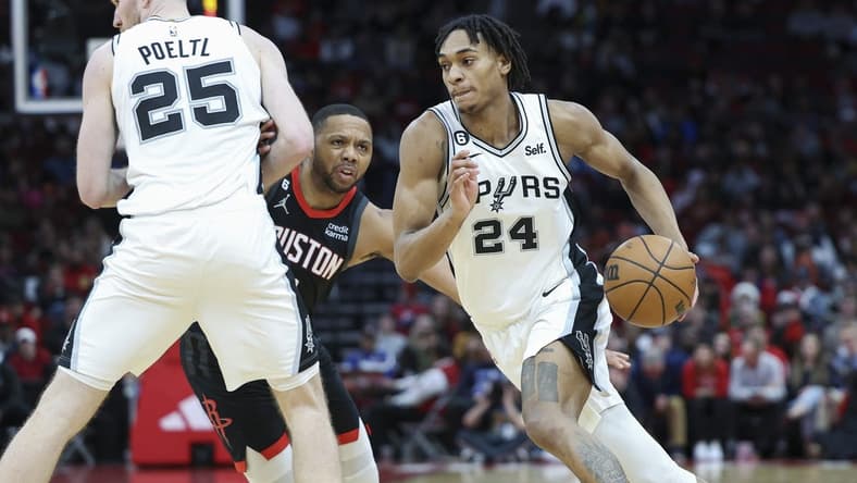 Dec 19, 2022; Houston, Texas, USA; San Antonio Spurs guard Devin Vassell (24) dribbles the ball as Houston Rockets guard Eric Gordon (10) defends during the fourth quarter at Toyota Center. Mandatory Credit: Troy Taormina-USA TODAY Sports