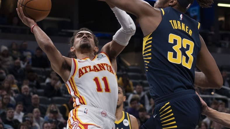 Dec 27, 2022; Indianapolis, Indiana, USA; Indiana Pacers center Myles Turner (33) attempts to block Atlanta Hawks guard Trae Young (11) during the game at Gainbridge Fieldhouse. Mandatory Credit: Armond Feffer-USA TODAY Sports