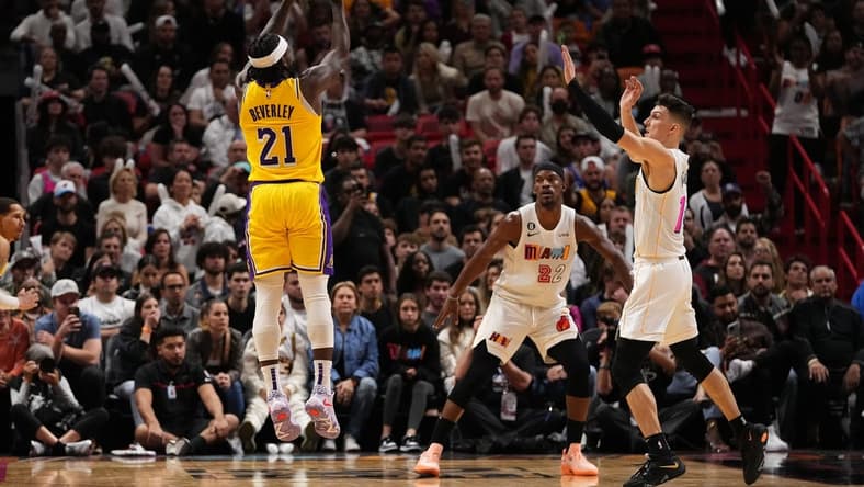 Dec 28, 2022; Miami, Florida, USA; Los Angeles Lakers guard Patrick Beverley (21) attempts a three point shot over Miami Heat guard Tyler Herro (14) during the second half at FTX Arena. Mandatory Credit: Jasen Vinlove-USA TODAY Sports