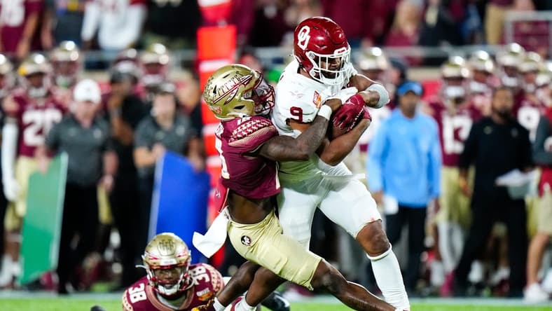 Dec 29, 2022; Orlando, Florida, USA; Florida State Seminoles defensive back Jammie Robinson (10) tackles Oklahoma Sooners tight end Brayden Willis (9) during the second half in the 2022 Cheez-It Bowl at Camping World Stadium. Mandatory Credit: Rich Storry-USA TODAY Sports