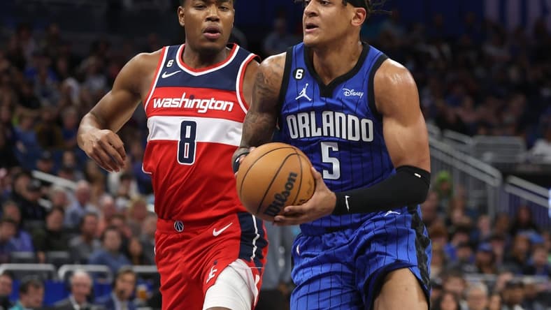 Dec 30, 2022; Orlando, Florida, USA; Orlando Magic forward Paolo Banchero (5) drives to the basket as Washington Wizards forward Rui Hachimura (8) defends during the first quarter at Amway Center. Mandatory Credit: Kim Klement-USA TODAY Sports