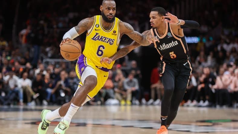 Dec 30, 2022; Atlanta, Georgia, USA; Los Angeles Lakers forward LeBron James (6) is defended by Atlanta Hawks guard Dejounte Murray (5) in the second half at State Farm Arena. Mandatory Credit: Brett Davis-USA TODAY Sports