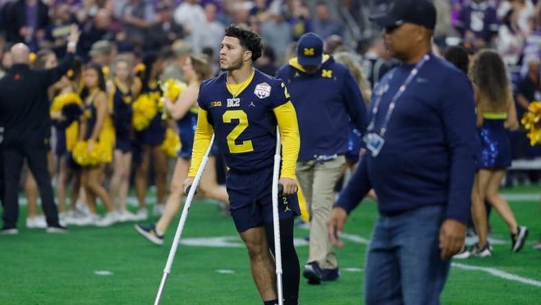 Michigan running back Blake Corum (2) is seen on the field on crutches before the start of the Fiesta Bowl against TCU on Saturday, Dec. 31 at State Farm Stadium in Glendale, Ariz.
H3 3755
