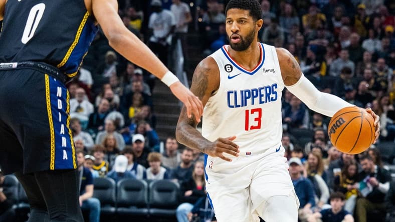 Dec 31, 2022; Indianapolis, Indiana, USA; LA Clippers guard Paul George (13) dribbles the ball while Indiana Pacers guard Tyrese Haliburton (0) defends in the first quarter at Gainbridge Fieldhouse. Mandatory Credit: Trevor Ruszkowski-USA TODAY Sports