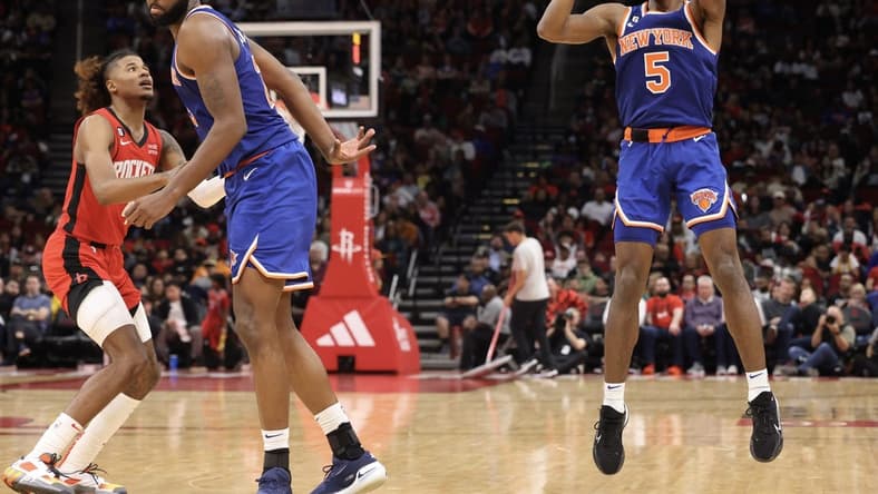 Dec 31, 2022; Houston, Texas, USA; New York Knicks guard Immanuel Quickley (5) shoots as center Mitchell Robinson (23) sets up a pick against Houston Rockets guard Jalen Green (4) in the third quarter at Toyota Center. Mandatory Credit: Thomas Shea-USA TODAY Sports