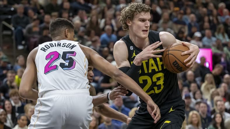Dec 31, 2022; Salt Lake City, Utah, USA; Utah Jazz forward-center Lauri Markkanen (23) battles for a rebound against Miami Heat center Orlando Robinson (25) during the first quarter at Vivint Arena. Mandatory Credit: Christopher Creveling-USA TODAY Sports