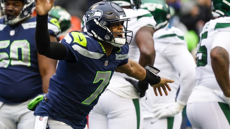 Jan 1, 2023; Seattle, Washington, USA; Seattle Seahawks quarterback Geno Smith (7) celebrates after showing a touchdown pass against the New York Jets during the second quarter at Lumen Field. Mandatory Credit: Joe Nicholson-USA TODAY Sports