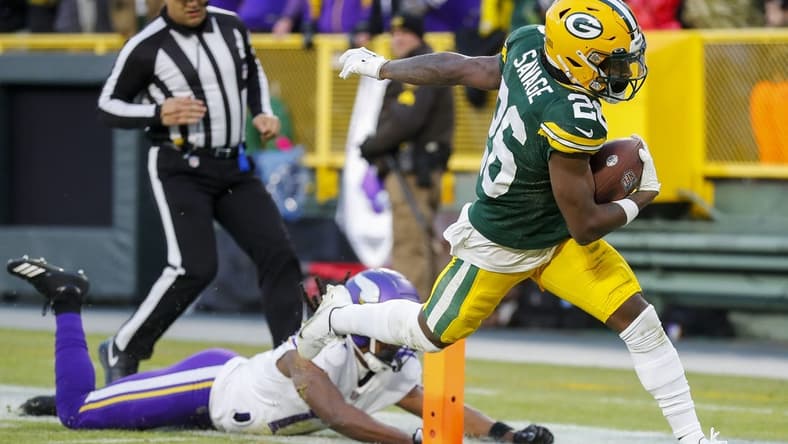 Jan 1, 2023; Green Bay, Wisconsin, USA; Green Bay Packers safety Darnell Savage (26) scores a touchdown on an interception return against the Minnesota Vikings at Lambeau Field. Mandatory Credit: Tork Mason-USA TODAY Sports