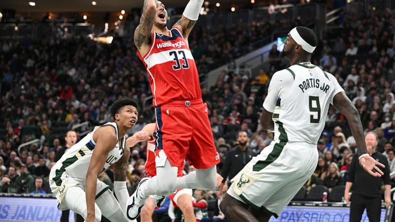 Jan 1, 2023; Milwaukee, Wisconsin, USA; Washington Wizards forward Kyle Kuzma (33) shoots the ball over Milwaukee Bucks forward Bobby Portis (9) in the first half at Fiserv Forum. Mandatory Credit: Michael McLoone-USA TODAY Sports