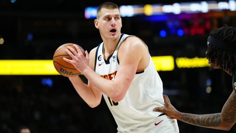 Jan 1, 2023; Denver, Colorado, USA; Denver Nuggets center Nikola Jokic (15) controls the ball in the second quarter against the Boston Celtics at Ball Arena. Mandatory Credit: Ron Chenoy-USA TODAY Sports