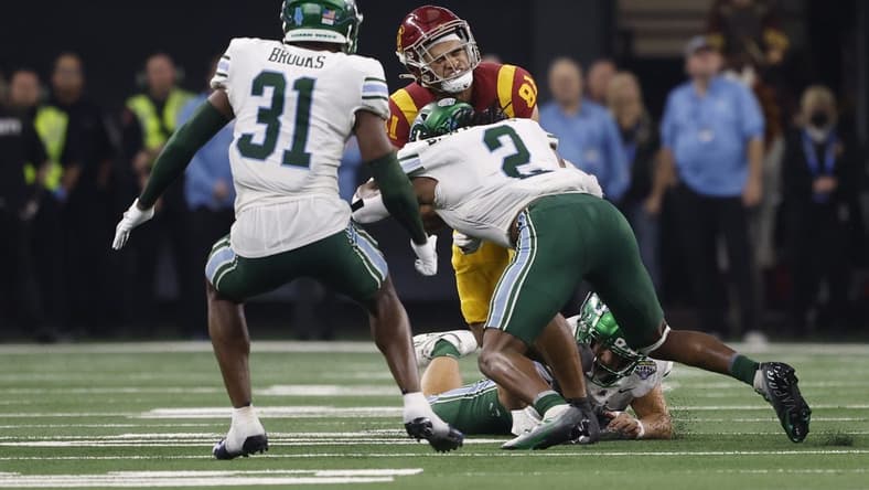 Jan 2, 2023; Arlington, Texas, USA; USC Trojans wide receiver Kyle Ford (81) is tackled by Tulane Green Wave linebacker Dorian Williams (2) in the second quarter in the 2023 Cotton Bowl at AT&T Stadium. Mandatory Credit: Tim Heitman-USA TODAY Sports