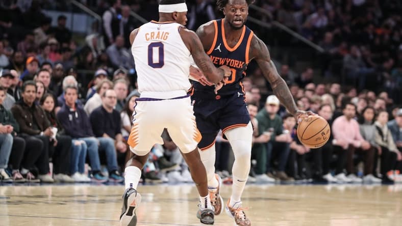 Jan 2, 2023; New York, New York, USA; New York Knicks forward Julius Randle (30) looks to drive past Phoenix Suns forward Torrey Craig (0) in the first quarter at Madison Square Garden. Mandatory Credit: Wendell Cruz-USA TODAY Sports