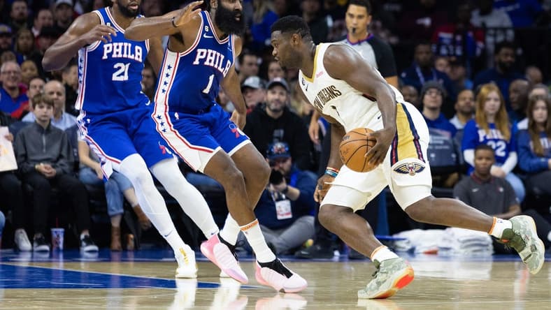 Jan 2, 2023; Philadelphia, Pennsylvania, USA; New Orleans Pelicans forward Zion Williamson (1) drives against Philadelphia 76ers guard James Harden (1) and center Joel Embiid (21) during the second quarter at Wells Fargo Center. Mandatory Credit: Bill Streicher-USA TODAY Sports