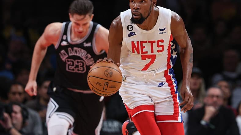 Jan 2, 2023; Brooklyn, New York, USA; Brooklyn Nets forward Kevin Durant (7) dribbles up court in front of San Antonio Spurs forward Zach Collins (23) during the first half at Barclays Center. Mandatory Credit: Vincent Carchietta-USA TODAY Sports