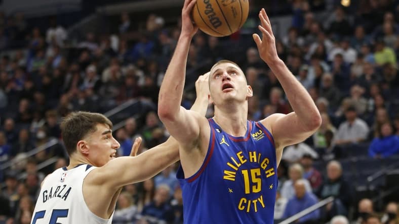 Jan 2, 2023; Minneapolis, Minnesota, USA; Denver Nuggets center Nikola Jokic (15) works around Minnesota Timberwolves center Luka Garza (55) in the first quarter at Target Center. Mandatory Credit: Bruce Kluckhohn-USA TODAY Sports