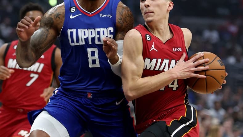 Jan 2, 2023; Los Angeles, California, USA;  Miami Heat guard Tyler Herro (14) drives to the basket against Los Angeles Clippers forward Marcus Morris Sr. (8) during the first quarter at Crypto.com Arena. Mandatory Credit: Kiyoshi Mio-USA TODAY Sports