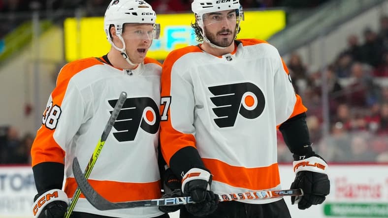 Dec 23, 2022; Raleigh, North Carolina, USA; Philadelphia Flyers center Patrick Brown (38) and center Zack MacEwen (17) talk against the Carolina Hurricanes during the second period at PNC Arena. Mandatory Credit: James Guillory-USA TODAY Sports