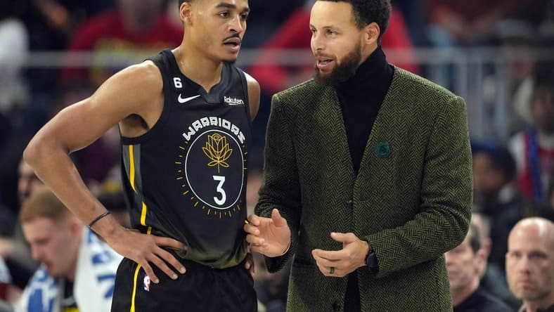 Dec 25, 2022; San Francisco, California, USA; Golden State Warriors guard Stephen Curry (right) talks to guard Jordan Poole (3) during the first quarter against the Memphis Grizzlies at Chase Center. Mandatory Credit: Darren Yamashita-USA TODAY Sports