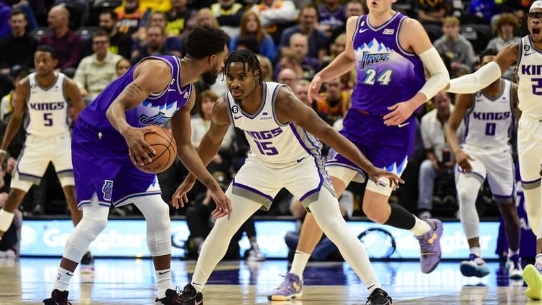 Jan 3, 2023; Salt Lake City, Utah, USA; Sacramento Kings guard Davion Mitchell (15) defends Utah Jazz guard Mike Conley (11) during the first quarter at Vivint Arena. Mandatory Credit: Christopher Creveling-USA TODAY Sports