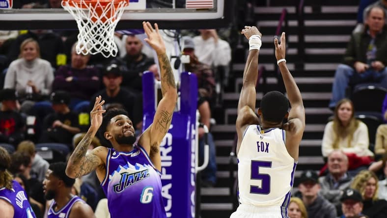 Jan 3, 2023; Salt Lake City, Utah, USA; Sacramento Kings guard De'Aaron Fox (5) shoots the ball over Utah Jazz guard Nickeil Alexander-Walker (6) during the fourth quarter at Vivint Arena. Mandatory Credit: Christopher Creveling-USA TODAY Sports