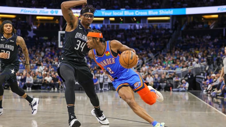 Jan 4, 2023; Orlando, Florida, USA; Oklahoma City Thunder guard Shai Gilgeous-Alexander (2) drives around Orlando Magic center Wendell Carter Jr. (34) during the first quarter at Amway Center. Mandatory Credit: Mike Watters-USA TODAY Sports