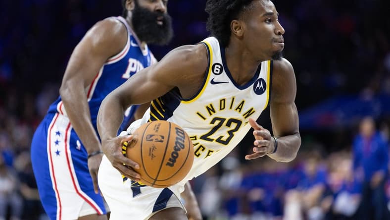 Jan 4, 2023; Philadelphia, Pennsylvania, USA; Indiana Pacers forward Aaron Nesmith (23) dribbles with the ball in front of Philadelphia 76ers guard James Harden (1) during the second quarter at Wells Fargo Center. Mandatory Credit: Bill Streicher-USA TODAY Sports
