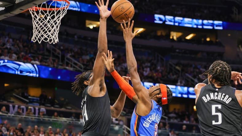 Jan 4, 2023; Orlando, Florida, USA; Orlando Magic center Wendell Carter Jr. (34) blocks a shot by Oklahoma City Thunder guard Shai Gilgeous-Alexander (2) during the second quarter at Amway Center. Mandatory Credit: Mike Watters-USA TODAY Sports