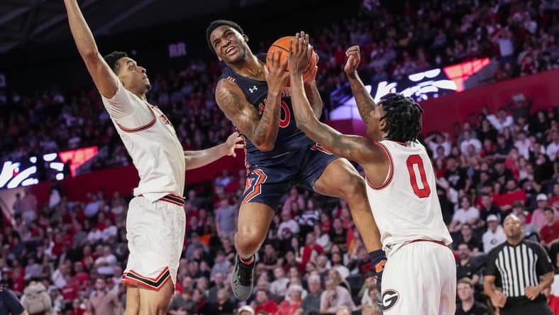 Jan 4, 2023; Athens, Georgia, USA; Auburn Tigers guard K.D. Johnson (0) tries to get past Georgia Bulldogs guard Terry Roberts (0) during the first half at Stegeman Coliseum. Mandatory Credit: Dale Zanine-USA TODAY Sports