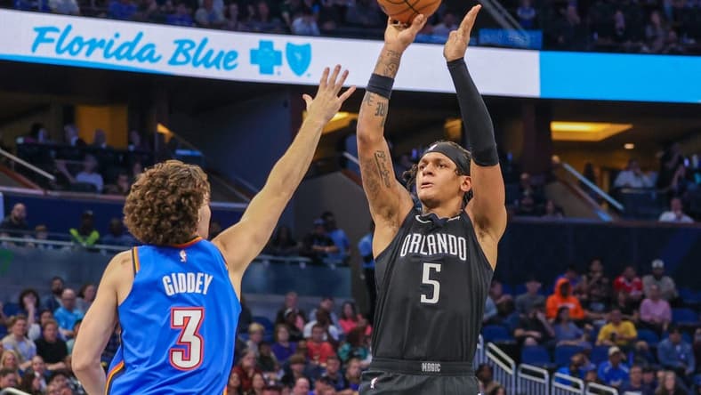 Jan 4, 2023; Orlando, Florida, USA; Orlando Magic forward Paolo Banchero (5) shoots the ball over Oklahoma City Thunder guard Josh Giddey (3) during the second half at Amway Center. Mandatory Credit: Mike Watters-USA TODAY Sports