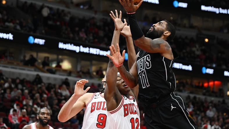 Jan 4, 2023; Chicago, Illinois, USA; Brooklyn Nets guard Kyrie Irving (11) shoots in the second half against Chicago Bulls guard Ayo Dosunmu (12) at United Center. Mandatory Credit: Quinn Harris-USA TODAY Sports