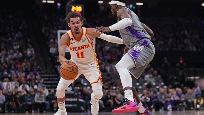Jan 4, 2023; Sacramento, California, USA; Atlanta Hawks guard Trae Young (11) dribbles past Sacramento Kings guard Terence Davis (3) in the first quarter at the Golden 1 Center. Mandatory Credit: Cary Edmondson-USA TODAY Sports