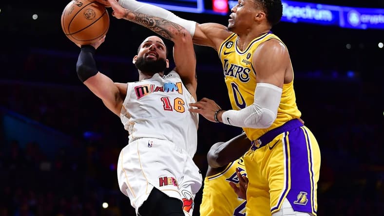 Jan 4, 2023; Los Angeles, California, USA; Miami Heat forward Caleb Martin (16) shoots against Los Angeles Lakers guard Russell Westbrook (0) during the first half at Crypto.com Arena. Mandatory Credit: Gary A. Vasquez-USA TODAY Sports