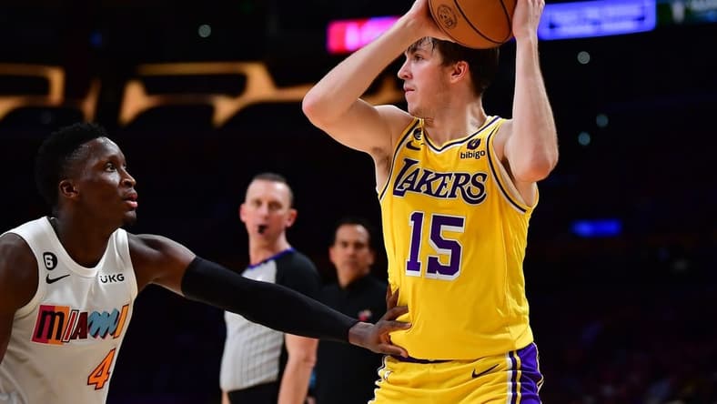 Jan 4, 2023; Los Angeles, California, USA; Los Angeles Lakers guard Austin Reaves (15) controls the ball against Miami Heat guard Victor Oladipo (4) during the second half at Crypto.com Arena. Mandatory Credit: Gary A. Vasquez-USA TODAY Sports