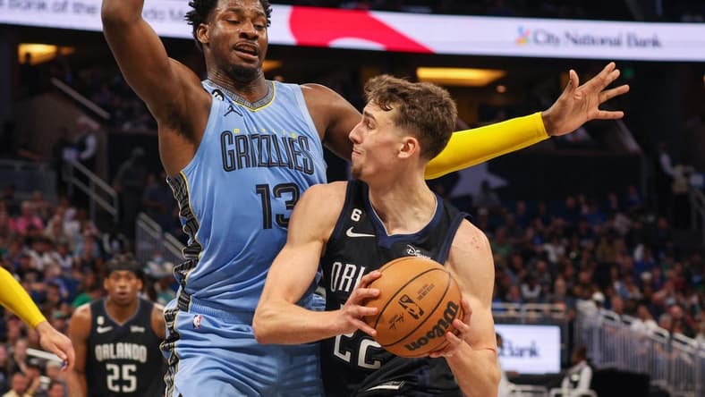 Jan 5, 2023; Orlando, Florida, USA; Orlando Magic forward Franz Wagner (22) drives to the basket past Memphis Grizzlies forward Jaren Jackson Jr. (13) in the second quarter at Amway Center. Mandatory Credit: Nathan Ray Seebeck-USA TODAY Sports
