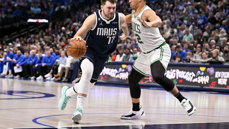 Jan 5, 2023; Dallas, Texas, USA; Dallas Mavericks guard Luka Doncic (77) drives to the basket against Boston Celtics forward Grant Williams (12) during the second half at the American Airlines Center. Mandatory Credit: Jerome Miron-USA TODAY Sports