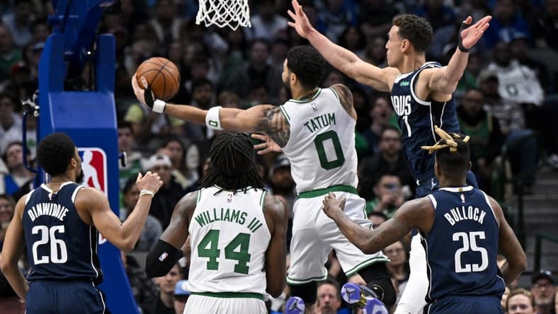 Jan 5, 2023; Dallas, Texas, USA; Boston Celtics forward Jayson Tatum (0) drives to the basket past Dallas Mavericks guard Spencer Dinwiddie (26) and forward Reggie Bullock (25) and center Dwight Powell (7) during the second half at the American Airlines Center. Mandatory Credit: Jerome Miron-USA TODAY Sports
