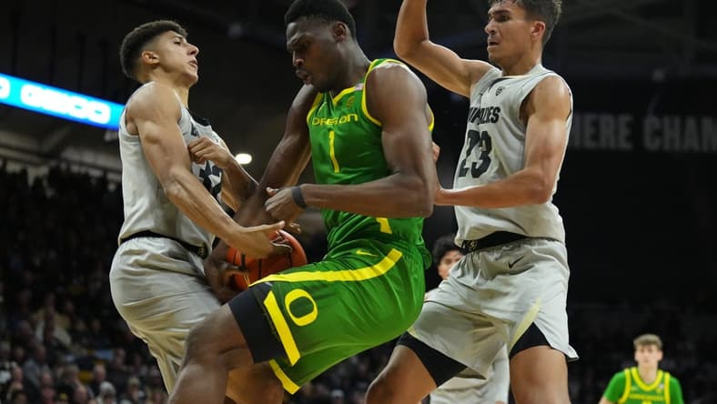 Jan 5, 2023; Boulder, Colorado, USA; Oregon Ducks center N'Faly Dante (1) and Colorado Buffaloes guard Nique Clifford (32) and forward Tristan da Silva (23) reach for a loose ball in the second half at the CU Events Center. Mandatory Credit: Ron Chenoy-USA TODAY Sports