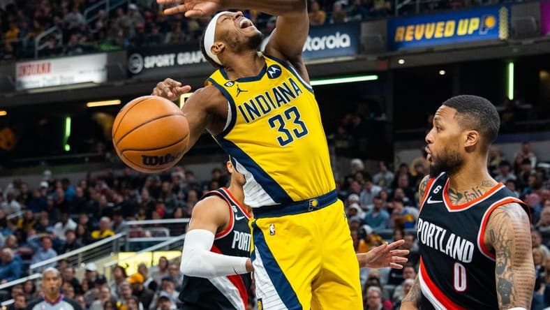 Jan 6, 2023; Indianapolis, Indiana, USA; Indiana Pacers center Myles Turner (33) shoots the ball while Portland Trail Blazers guard Damian Lillard (0) defends in the second quarter at Gainbridge Fieldhouse. Mandatory Credit: Trevor Ruszkowski-USA TODAY Sports