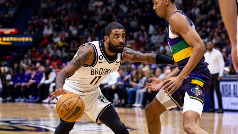 Jan 6, 2023; New Orleans, Louisiana, USA;  Brooklyn Nets guard Kyrie Irving (11) dribbles against New Orleans Pelicans guard Trey Murphy III (25) during the first half  at Smoothie King Center. Mandatory Credit: Stephen Lew-USA TODAY Sports