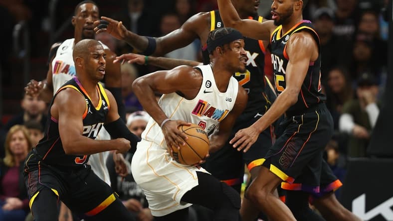 Jan 6, 2023; Phoenix, Arizona, USA; Phoenix Suns guard Chris Paul (left) and forward Mikal Bridges (right) defend against Miami Heat forward Jimmy Butler (center) in the first half at Footprint Center. Mandatory Credit: Mark J. Rebilas-USA TODAY Sports