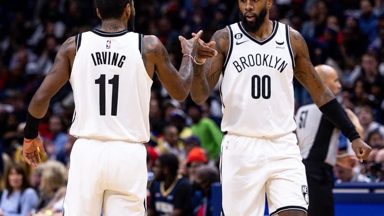 Jan 6, 2023; New Orleans, Louisiana, USA;  Brooklyn Nets guard Kyrie Irving (11) and forward Royce O'Neale (00) react to a play against the New Orleans Pelicans during the second half at Smoothie King Center. Mandatory Credit: Stephen Lew-USA TODAY Sports