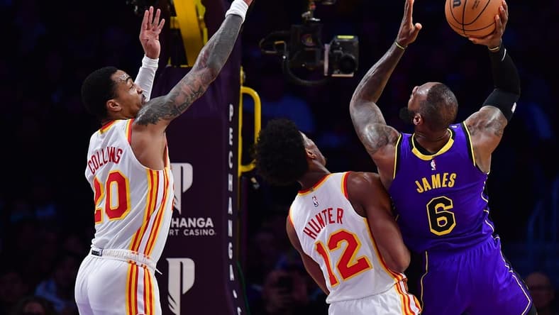 Jan 6, 2023; Los Angeles, California, USA; Los Angeles Lakers forward LeBron James (6) moves to the basket against Atlanta Hawks forward De'Andre Hunter (12) and forward John Collins (20) during the first half at Crypto.com Arena. Mandatory Credit: Gary A. Vasquez-USA TODAY Sports