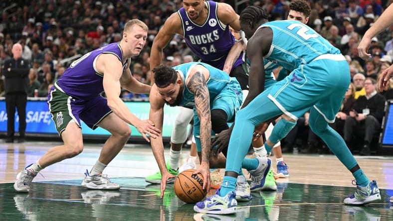 Jan 6, 2023; Milwaukee, Wisconsin, USA; Charlotte Hornets forward Cody Martin (11) and Milwaukee Bucks guard AJ Green (20) scramble for a loose ball in the first half at Fiserv Forum. Mandatory Credit: Michael McLoone-USA TODAY Sports