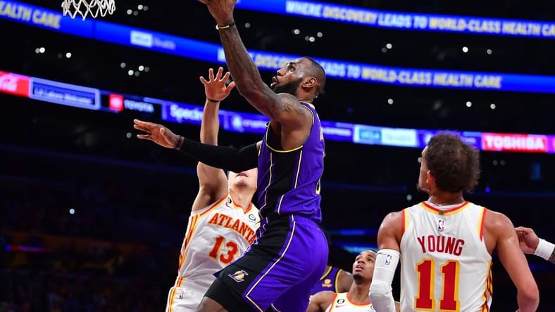 Jan 6, 2023; Los Angeles, California, USA; Los Angeles Lakers forward LeBron James (6) moves to the basket against Atlanta Hawks guard Bogdan Bogdanovic (13) and guard Trae Young (11) during the second half at Crypto.com Arena. Mandatory Credit: Gary A. Vasquez-USA TODAY Sports