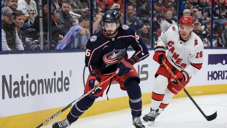 Jan 7, 2023; Columbus, Ohio, USA; Columbus Blue Jackets right wing Kirill Marchenko (86) controls the puck against Carolina Hurricanes center Paul Stastny (26) in the second period at Nationwide Arena. Mandatory Credit: Aaron Doster-USA TODAY Sports