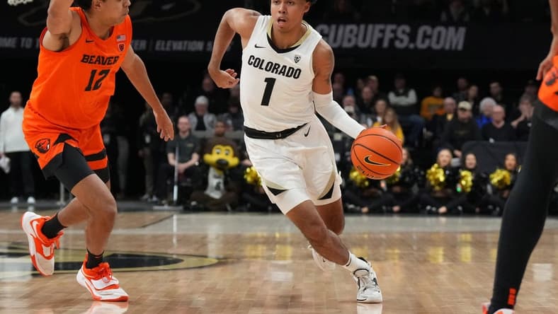 Jan 7, 2023; Boulder, Colorado, USA; Colorado Buffaloes guard Julian Hammond III (1) dribbles past Oregon State Beavers forward Michael Rataj (12) in the first half at CU Events Center. Mandatory Credit: Ron Chenoy-USA TODAY Sports