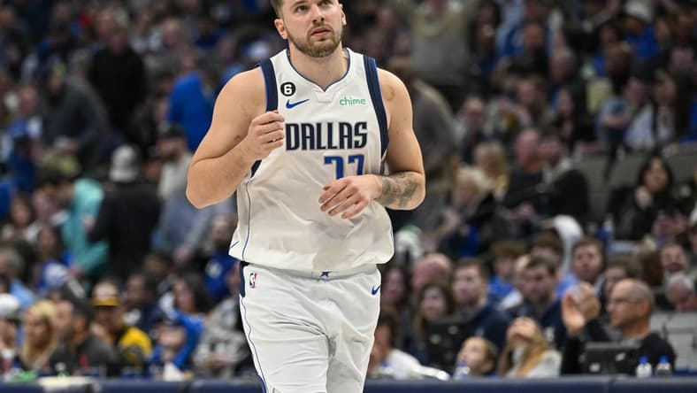 Jan 7, 2023; Dallas, Texas, USA; Dallas Mavericks guard Luka Doncic (77) motions to the crown as he runs back up the court after making an assist against the New Orleans Pelicans during the second half at the American Airlines Center. Mandatory Credit: Jerome Miron-USA TODAY Sports