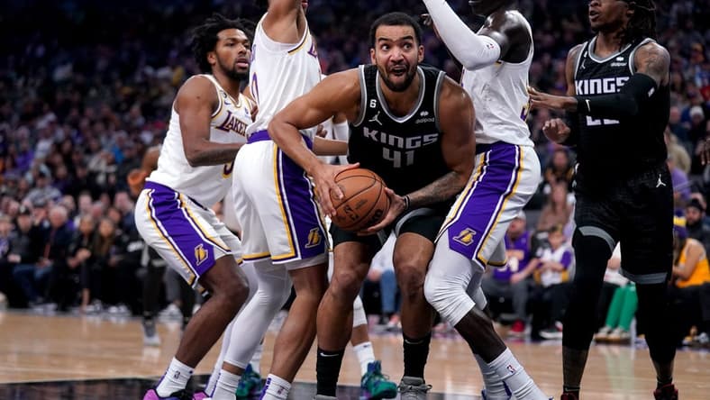 Jan 7, 2023; Sacramento, California, USA; Sacramento Kings forward Trey Lyles (41) holds onto the ball between Los Angeles Lakers guard Max Christie (10) and forward Wenyen Gabriel (35) in the first quarter at the Golden 1 Center. Mandatory Credit: Cary Edmondson-USA TODAY Sports